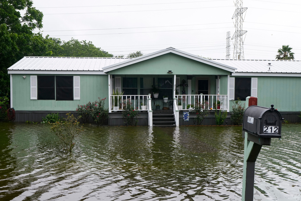 Water surrounds homes in the aftermath of Tropical Storm Arthur in rural Brazoria County, Texas, Wednesday, June 17, 2026. (Brett Coomer/Houston Chronicle via AP)