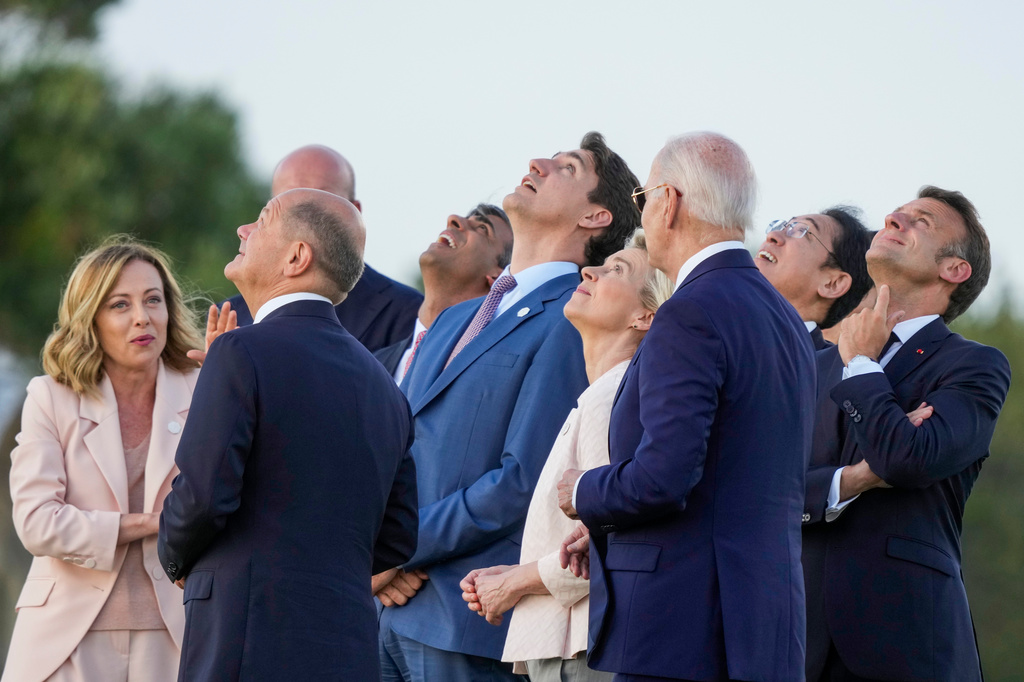FILE -- From right, French President Emmanuel Macron, Japan's Prime Minister Fumio Kishida, U.S. President Joe Biden, European Commission President Ursula von der Leyen, Canada's Prime Minister Justin Trudeau, Britain's Prime Minister Rishi Sunak, European Council President Charles Michel, German Chancellor Olaf Scholz and Italian Prime Minister Giorgia Meloni watch a skydiving demo during the G7 world leaders summit at Borgo Egnazia, Italy, Thursday, June 13, 2024. (AP Photo/Luca Bruno, File)
