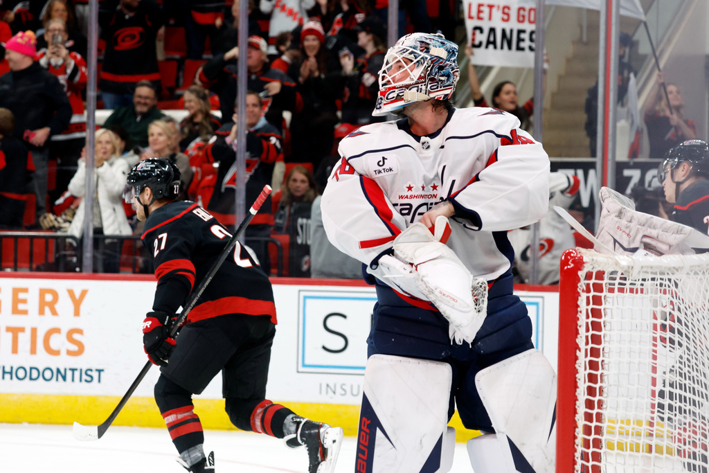 Washington Capitals goaltender Logan Thompson (48) watches the replay as the goal scorer Carolina Hurricanes' Nikolaj Ehlers (27) skates back to the bench during the second period of an NHL hockey game in Raleigh, N.C., Tuesday, Nov. 11, 2025. (AP Photo/Karl DeBlaker)