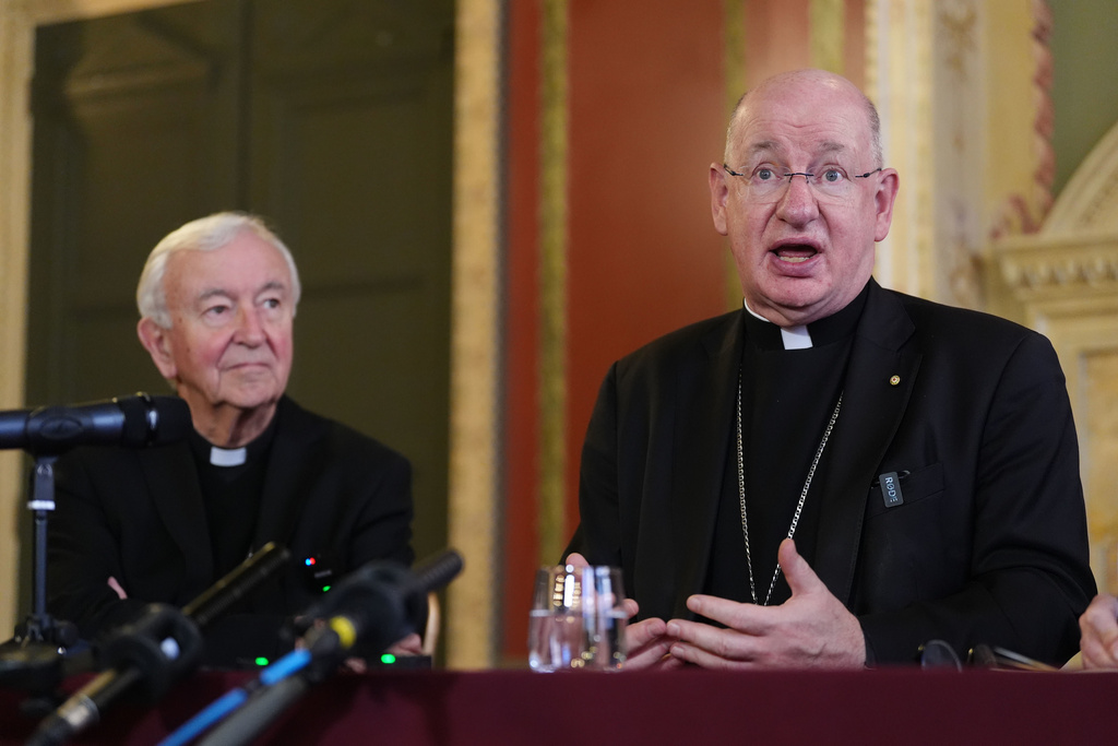 Outgoing archbishop of Westminster Vincent Nichols, left, listens to Bishop Richard Moth speaking during a press conference announcing him as the new Archbishop of Westminster, replacing Cardinal Vincent Nichols as the leader of the Catholic Church in England and Wales, in the Throne Room of Archbishop's House, Westminster, London, Friday Dec. 19, 2025. (Jonathan Brady/PA via AP)