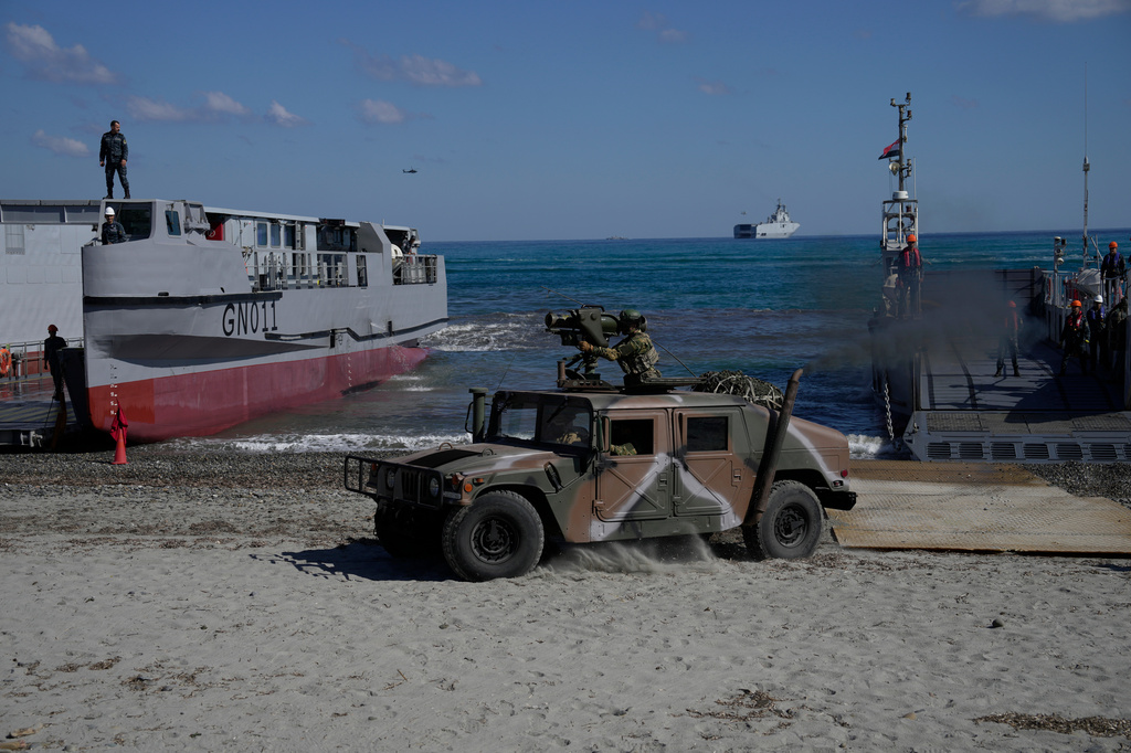 Greek service members drive a military vehicle ashore from a landing craft during Medusa 15, a multinational military exercise led by Greece and Egypt, in Maleme on the Greek island of Crete, Friday, Sept. 18, 2026. (AP Photo/Thanassis Stavrakis)