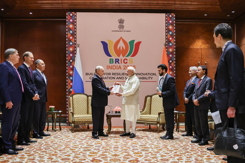 Russian President Vladimir Putin, center left, and Indian Prime Minister Narendra Modi, center right, talk to each other during their meeting on the sidelines of the BRICS Summit in New Delhi, India, on Friday, Sept. 11, 2026. (Alexander Kazakov, Sputnik, Kremlin Pool Photo via AP)