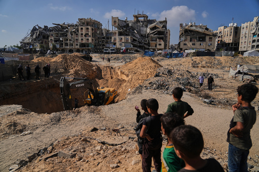 Palestinians watch as Egyptian machinery and workers search for the bodies of hostages in Hamad City, Khan Younis, in the southern Gaza Strip, Tuesday, Oct. 28, 2025. (AP Photo/Abdel Kareem Hana) Palestinians watch as Egyptian machinery and workers search for the bodies of hostages in Hamad City, Khan Younis, in the southern Gaza Strip, Tuesday, Oct. 28, 2025. (AP Photo/Abdel Kareem Hana)