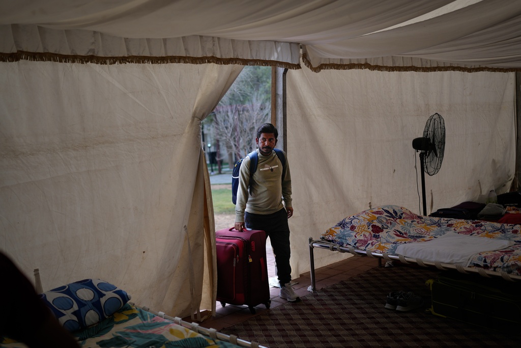 A stranded Indian traveler arrives at a farmhouse owned by an Indian businessman, now converted into a shelter in Ajman, near Dubai, United Arab Emirates, Saturday, March 7, 2026. (AP Photo/Altaf Qadri)