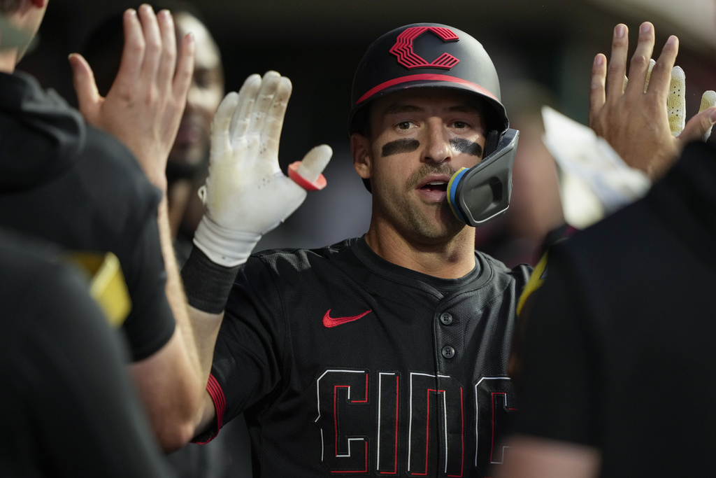 Cincinnati Reds' Spencer Steer celebrates in the dugout after hitting a solo home run during the sixth inning of a baseball game against the St. Louis Cardinals Friday, Aug. 29, 2025, in Cincinnati. (AP Photo/Carolyn Kaster)