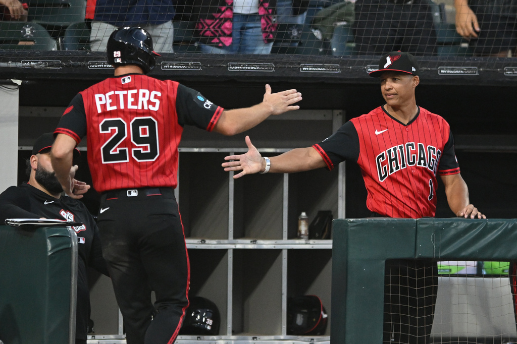 Chicago White Sox's Tristan Peters (29) celebrates with manager Will Venable, right, at the dugout after scoring on a Miguel Vargus sacrifice fly during the fifth inning of a baseball game against the Athletics in Chicago, Friday, July 10, 2026. (AP Photo/Paul Beaty)