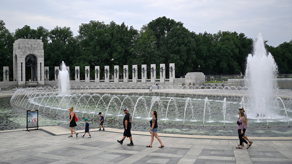 Visitors walk the WWII memorial the morning after it was vandalized, shown Friday, Aug. 14, 2026, in Washington. (AP Photo/John McDonnell)