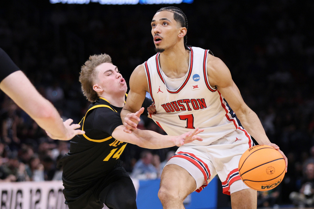 Houston guard Milos Uzan (7) drives against Idaho guard Kolton Mitchell (14) during the first half in the first round of the NCAA college basketball tournament, Thursday, March 19, 2026, in Oklahoma City. (AP Photo/Nate Billings)