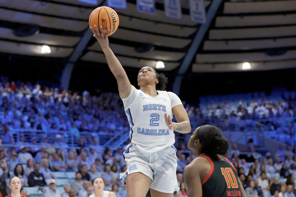 North Carolina forward Nyla Harris (2) drives against Maryland guard Mir McLean (10) during the first half in the second round of the NCAA college basketball tournament, Sunday, March 22, 2026, in Chapel Hill, N.C. (AP Photo/Chris Seward)