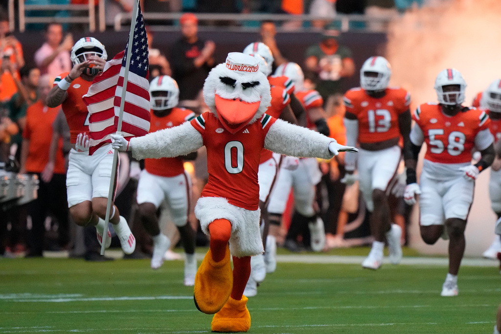 FILE - Miami mascot, Sebastian the Ibis, leads the team onto the field before the start of an NCAA college football game against Ohio, Sept. 1, 2023, in Miami Gardens, Fla. (AP Photo/Wilfredo Lee, File)
