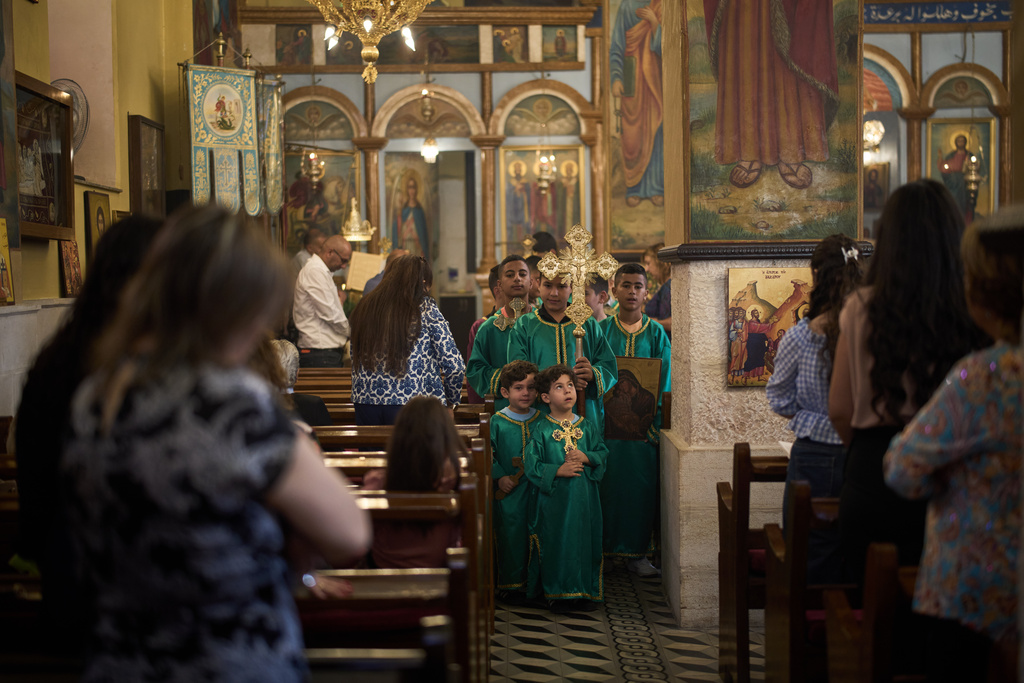 Palestinian children attend morning Mass at the Greek Orthodox Church of St. George in the West Bank village of Taybeh, Sept. 28, 2025. (AP Photo/Leo Correa)
