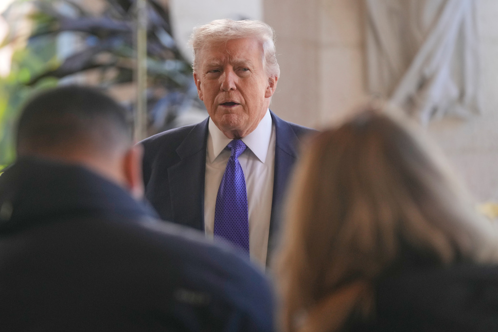 President Donald Trump speaks to reporters at his Mar-a-Lago club, Sunday, Feb. 1, 2026, in Palm Beach, Fla., as he arrives to attend the wedding of White House deputy chief of staff Dan Scavino and Erin Elmore, the director of Art in Embassies at the U.S. Department of State. (AP Photo/Mark Schiefelbein)