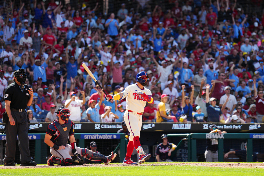 Philadelphia Phillies' Kyle Schwarber, right, watches his solo home run off Atlanta Braves pitcher Dylan Dodd during the seventh inning of a baseball game, Sunday, Sept. 6, 2026, in Philadelphia. (AP Photo/Derik Hamilton)
