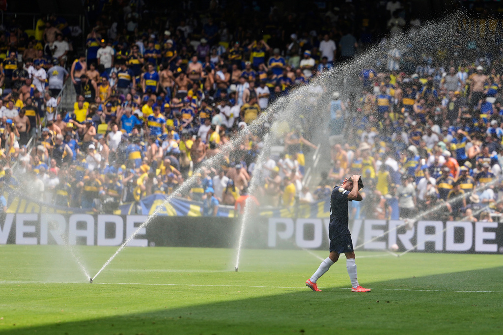 FILE - Auckland City's Gerard Garriga cools off under the sprinklers during a hydration break in the Club World Cup Group C soccer match between Auckland City and Boca Juniors in Nashville, Tenn., Tuesday, June 24, 2025. (AP Photo/George Walker IV, File)