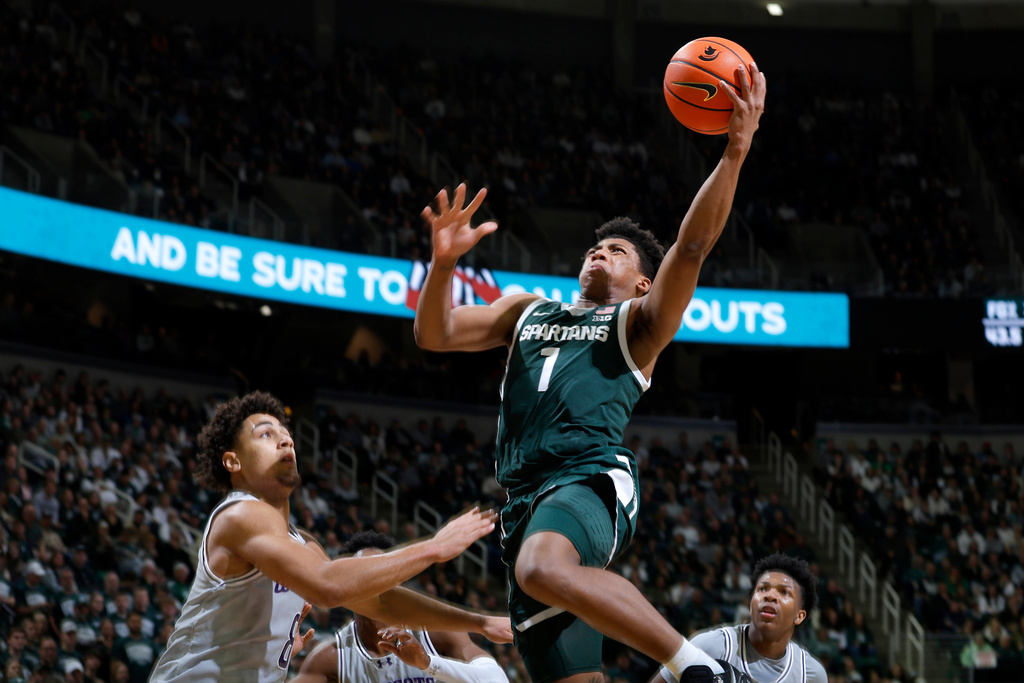 Michigan State guard Jeremy Fears Jr. (1) goes up to shoot against Northwestern forward Tre Singleton, left, during the second half of an NCAA college basketball game, Thursday, Jan. 8, 2026, in East Lansing, Mich. (AP Photo/Al Goldis)