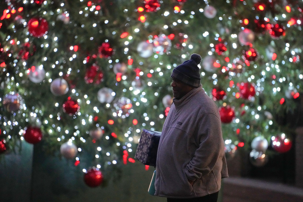 Ahmad Collins heads for his office in Harrisburg, Pa., Thursday, Dec. 11, 2025. A city government worker and former Penn State linebacker, Collins has needed 10 hours a night of dialysis since a medical procedure left him with damaged kidneys late last year. (AP Photo/Matt Rourke)