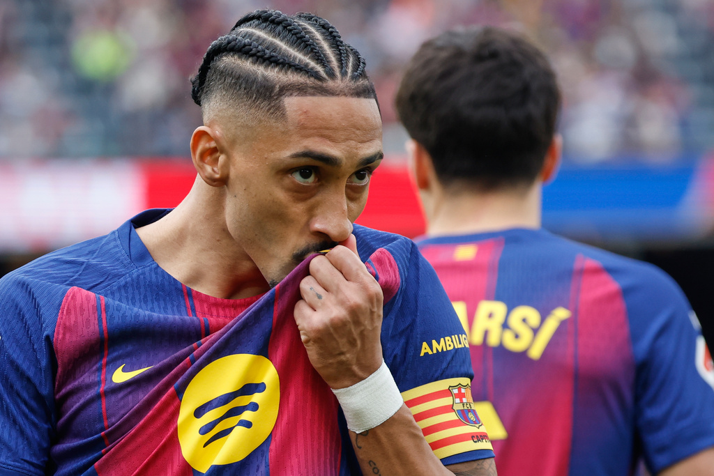 Barcelona's Raphinha celebrates after scoring his side's opening goal during the Spanish La Liga soccer match between Barcelona and Sevilla in Barcelona, Spain, Sunday, March 15, 2026. (AP Photo/Joan Monfort)