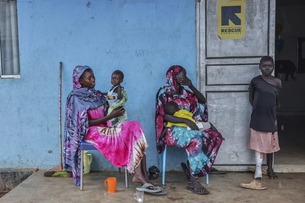 Patients sit outside the malnutrition ward of Bunj Hospital in Maban, South Sudan, Tuesday, Aug. 19, 2025. (AP Photo/Caitlin Kelly)