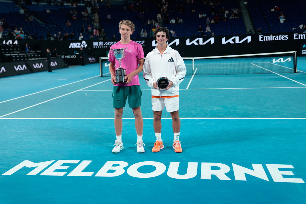Ziga Sesko, left, of Slovenia poses with his trophy after defeating Keaton Hance, right, of the U.S. in the boy's singles final at the Australian Open tennis championship in Melbourne, Australia, Sunday, Feb. 1, 2026. (AP Photo/Dar Yasin)