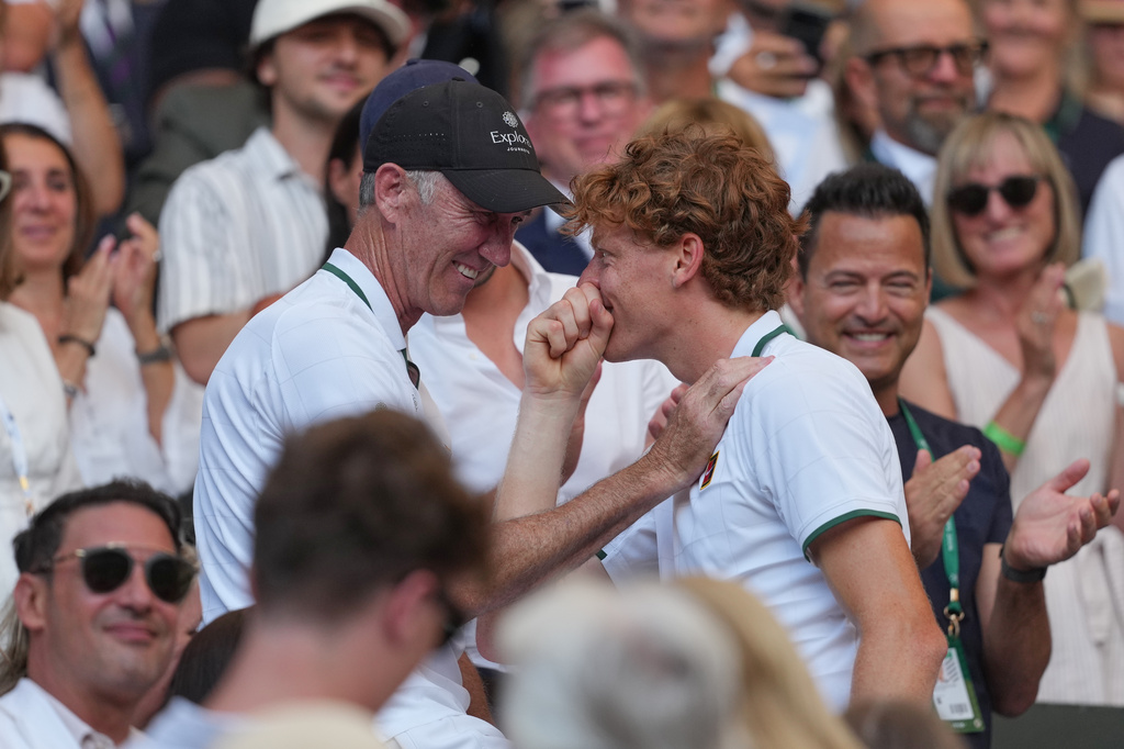 Jannik Sinner of Italy embraces coaches and family after winning the men's singles final, defeating Alexander Zverev of Germany, at Wimbledon Tennis Championships in London, Sunday, July 12, 2026. (AP Photo/Kin Cheung)