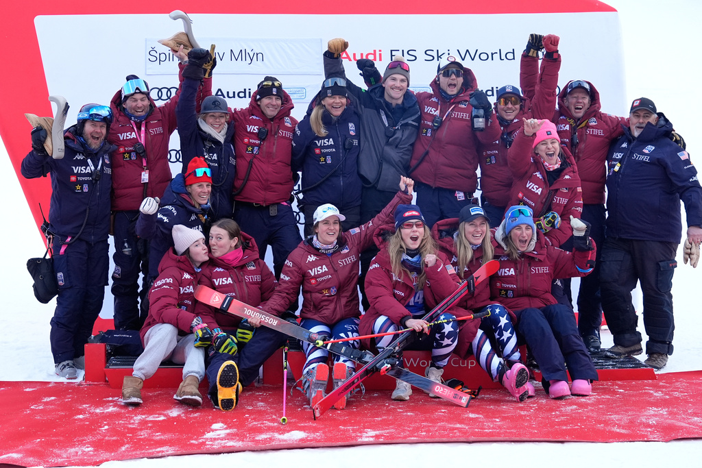 United States' Paula Moltzan, bottom, third from left, and Mikaela Shiffrin, bottom, third from right, pose with the US team after a women's alpine ski, World Cup giant slalom, in Spindleruv Mlyn, Czech Republic, Saturday, Jan. 24, 2026. (AP Photo/Giovanni Auletta)