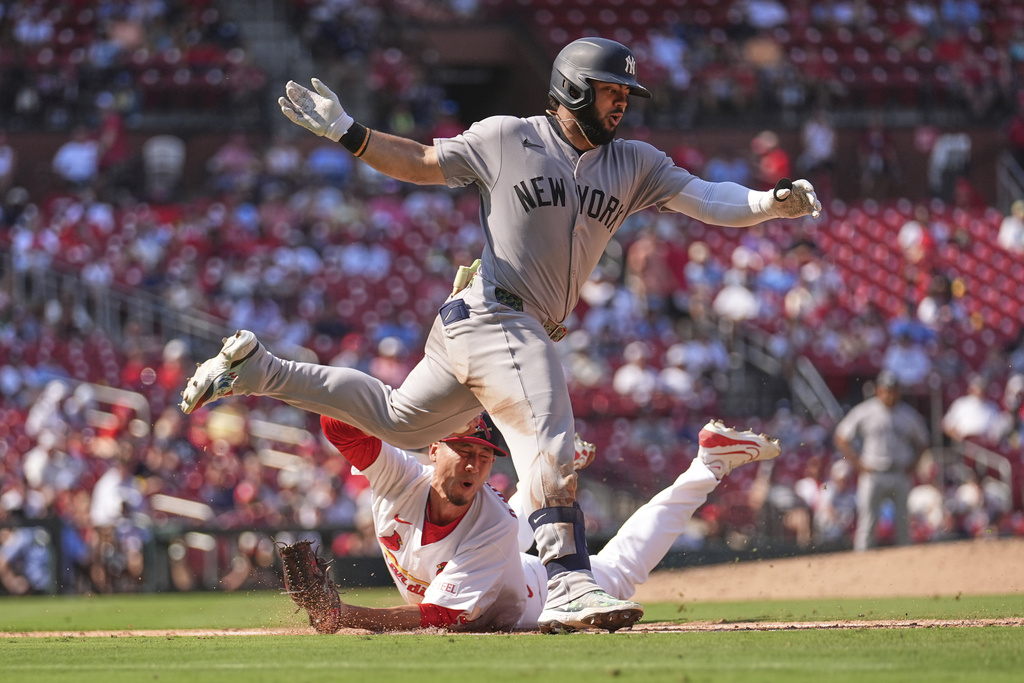 New York Yankees' Jasson Dominguez, top, is tagged out by St. Louis Cardinals relief pitcher Riley O'Brien during the eighth inning of a baseball game Sunday, Aug. 17, 2025, in St. Louis. (AP Photo/Jeff Roberson)