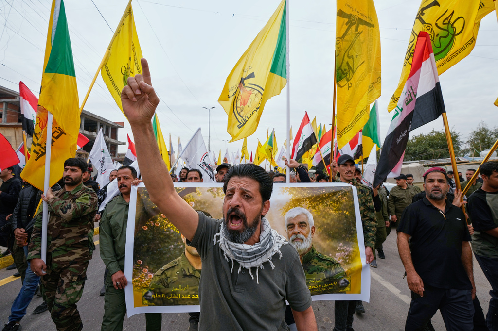 Members from the Popular Mobilization Forces attend a funeral of fighters who were killed in a U.S. airstrike, in Tal Afar, Nineveh province, north of Baghdad, Iraq, Thursday, April 2, 2026. (AP Photo/Hadi Mizban)