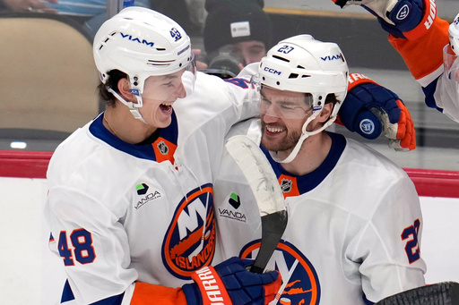 New York Islanders' Jonathan Drouin (29) celebrates after his goal with Matthew Schaefer (48) during the first period of an NHL hockey game against the Pittsburgh Penguins in Pittsburgh, Thursday, Oct. 9, 2025. (AP Photo/Gene J. Puskar) New York Islanders' Jonathan Drouin (29) celebrates after his goal with Matthew Schaefer (48) during the first period of an NHL hockey game against the Pittsburgh Penguins in Pittsburgh, Thursday, Oct. 9, 2025. (AP Photo/Gene J. Puskar)