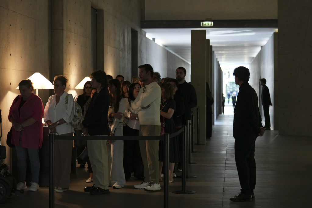 People line up in Milan, northern Italy, Saturday, Sep. 6, 2025, to pay their respects to fashion designer Giorgio Armani, who died Thursday at age 91. (AP Photo/Antonio Calanni)