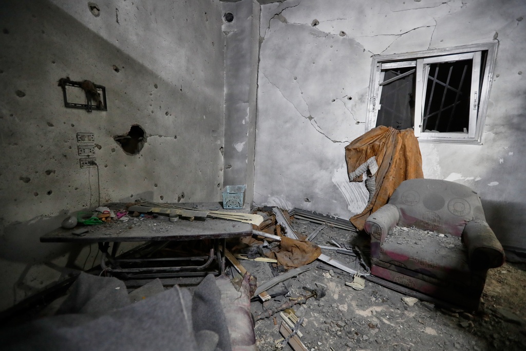 Debris is seen scattered at a home in Damascus, Syria, Friday, Nov. 14, 2025, after it was hit by rockets, according to state media. It was not immediately clear who was behind the attack. (AP Photo/Omar Sanadiki)