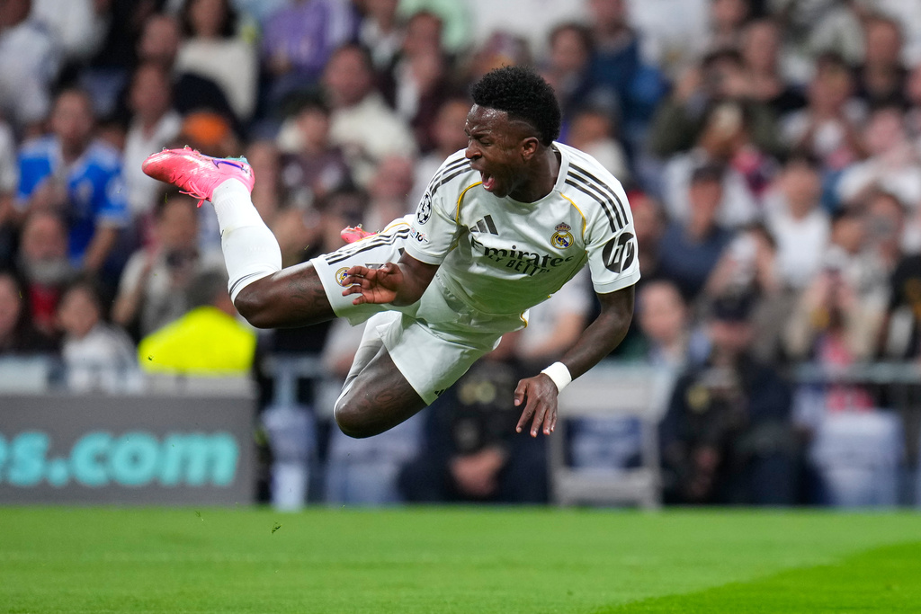 Real Madrid's Vinicius Junior falls during the second leg of the Champions League playoff soccer match between Real Madrid and Benfica in Madrid, Spain, Wednesday, Feb. 25, 2026. (AP Photo/Manu Fernandez)