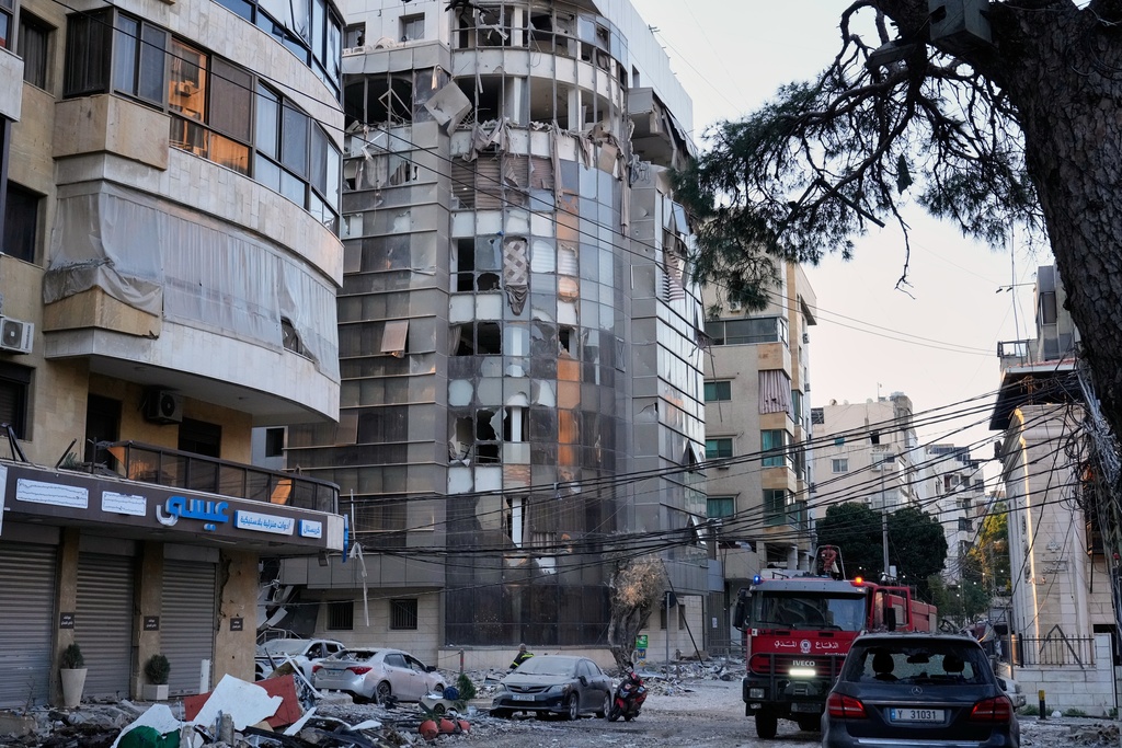 Debris covers a street beside an apartment building hit by an Israeli airstrike in Dahiyeh, Beirut's southern suburb, Lebanon, Monday, March 2, 2026. (AP Photo/Hussein Malla)