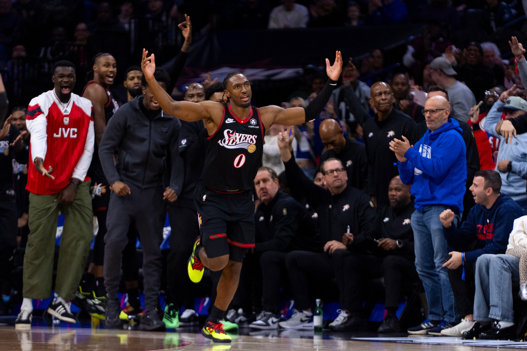 Philadelphia 76ers' Tyrese Maxey (0) reacts after the second of his back-to-back 3-point baskets during the first half of an NBA basketball game against the Miami Heat, Sunday, Nov. 23, 2025, in Philadelphia. (AP Photo/Chris Szagola)