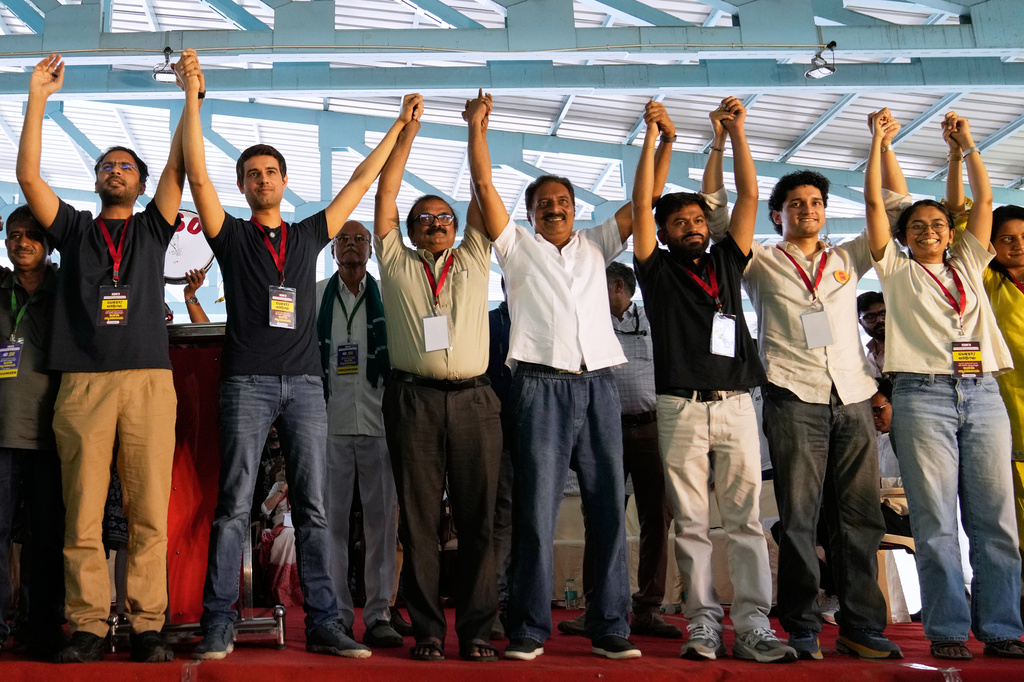 Indian influencer and activist Dhruv Rathee, second left, Indian actor Prakash Raj, fourth left, Cockroach Janta Party founder Abhijeet Dipke, fifth left and other supporters join hands during a protest demanding the resignation of the country's election chief Gyanesh Kumar, in Bengaluru, India, Thursday, Oct. 8, 2026. (AP Photo/Aijaz Rahi)