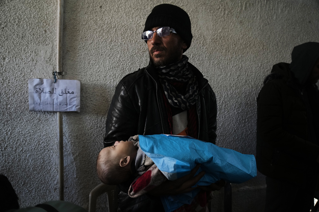 Khalid Abu Jarad holds the body of his 3-month-old niece, Shaza Abu Jarad, who, according to the health ministry, died from hypothermia, in Gaza City, Tuesday, Jan. 20, 2026. (AP Photo/Jehad Alshrafi)