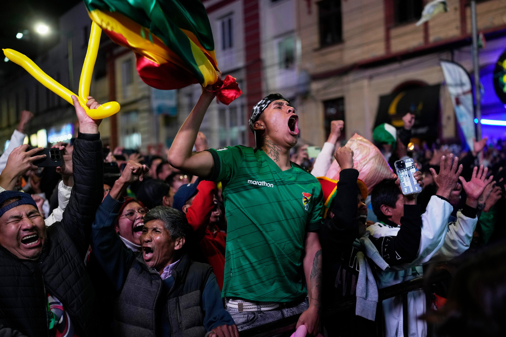 Bolivia fans cheer after their country's second goal against Suriname in a World Cup 2026 playoff semifinal held in Mexico, in La Paz, Bolivia, Thursday, March 26, 2026. (AP Photo/Juan Karita)