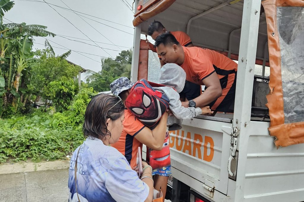 In this photo, provided by the Philippine Coast Guard, residents are evacuated to safer grounds as Typhoon Kalmaegi nears the area of Guiuan, Eastern Samar province, central Philippines on Monday Nov. 3, 2025. (Philippine Coast Guard via AP)
