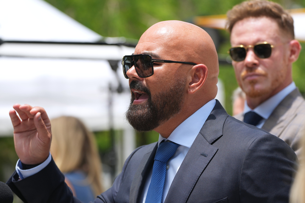 Attorney Joseph McBride, representing Andrew and Tristan Tate after they were arrested to face rape and sex trafficking charges against them in the United Kingdom, speaks with the news media outside of the C. Clyde Atkins U.S. Courthouse, Monday, July 20, 2026, in Miami. (AP Photo/Lynne Sladky)