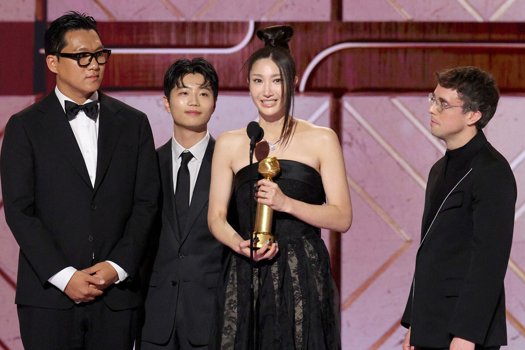 This image released by CBS Broadcasting shows Ejae, second right, accepting the award for best original song for "Golden" from the film "KPop Demon Hunters" during the 83rd Golden Globes on Sunday, Jan. 11, 2026, at the Beverly Hilton in Beverly Hills, Calif. (Kevork Djansezian/CBS Broadcasting via AP)