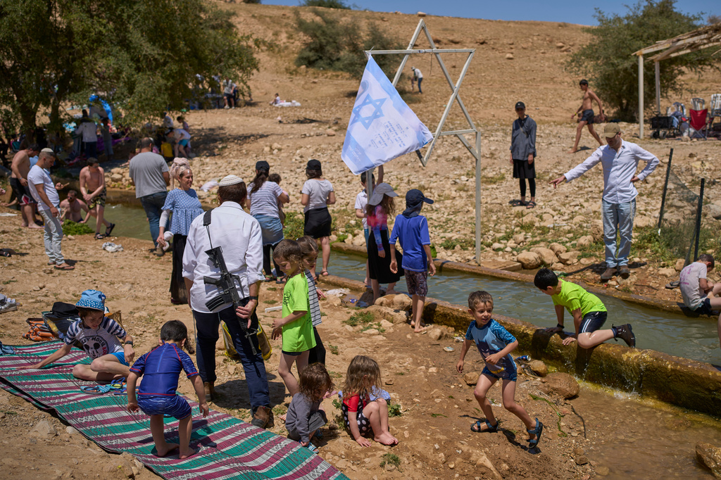 Israelis enjoy a day at a spring in Auja, in the Jordan Valley, during Israel's Independence Day on Wednesday, April 22, 2026, in the occupied West Bank. (AP Photo/Ohad Zwigenberg)