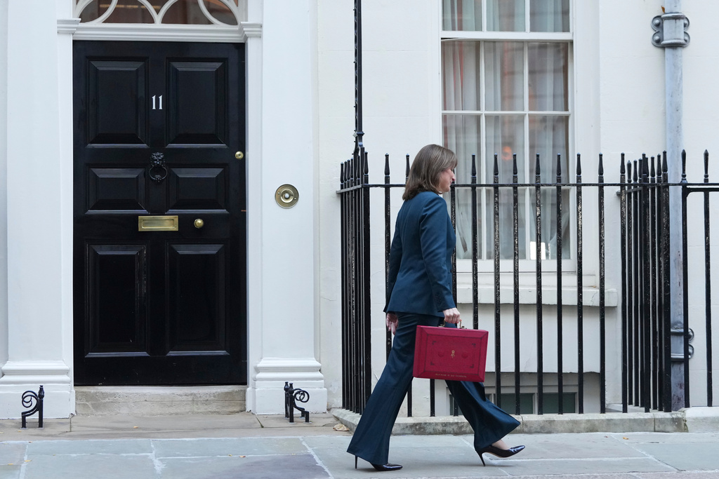 Britain's Chancellor of the Exchequer Rachel Reeves departs 11 Downing Street with her ministerial red box before heading to the House of Commons to deliver her Budget speech in London, Wednesday, Nov. 26, 2025. (AP Photo/Kirsty Wigglesworth)