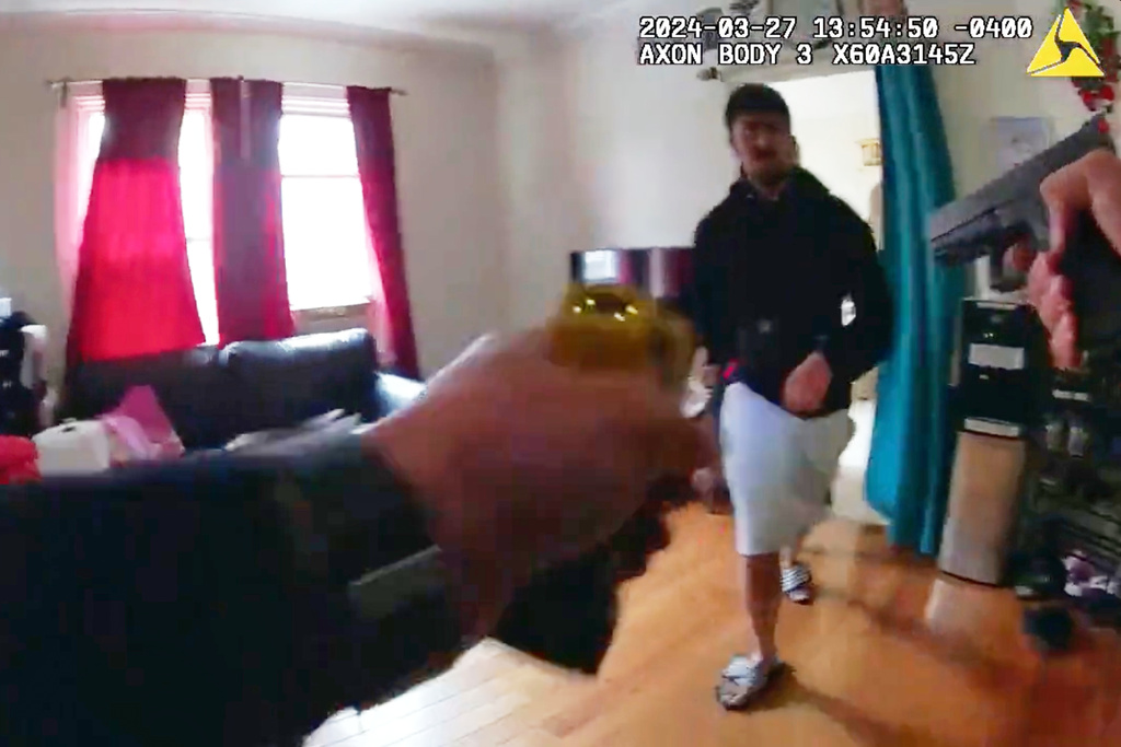 This image made from New York Police Department body camera footage released by the New York Attorney General's Office shows an officer pointing his gun at Win Rozario in Rozario's family home on March 27, 2025, in the Queens borough of New York. (New York Police Department/New York Attorney General's Office via AP)
