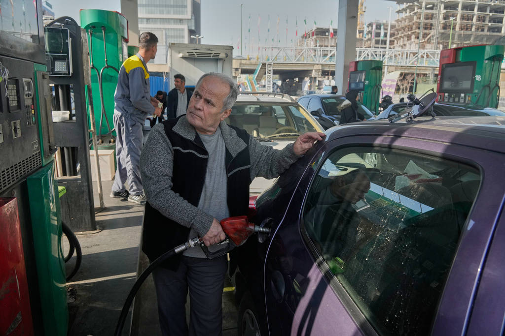 A man fills his car at a gas station in Tehran, Iran, Saturday, Dec. 13, 2025. (AP Photo/Vahid Salemi)