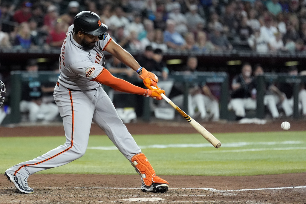 San Francisco Giants' Jerar Encarnacion connects for a run-scoring single against the Arizona Diamondbacks during the 11th inning of a baseball game Wednesday, Sept. 17, 2025, in Phoenix. (AP Photo/Ross D. Franklin)