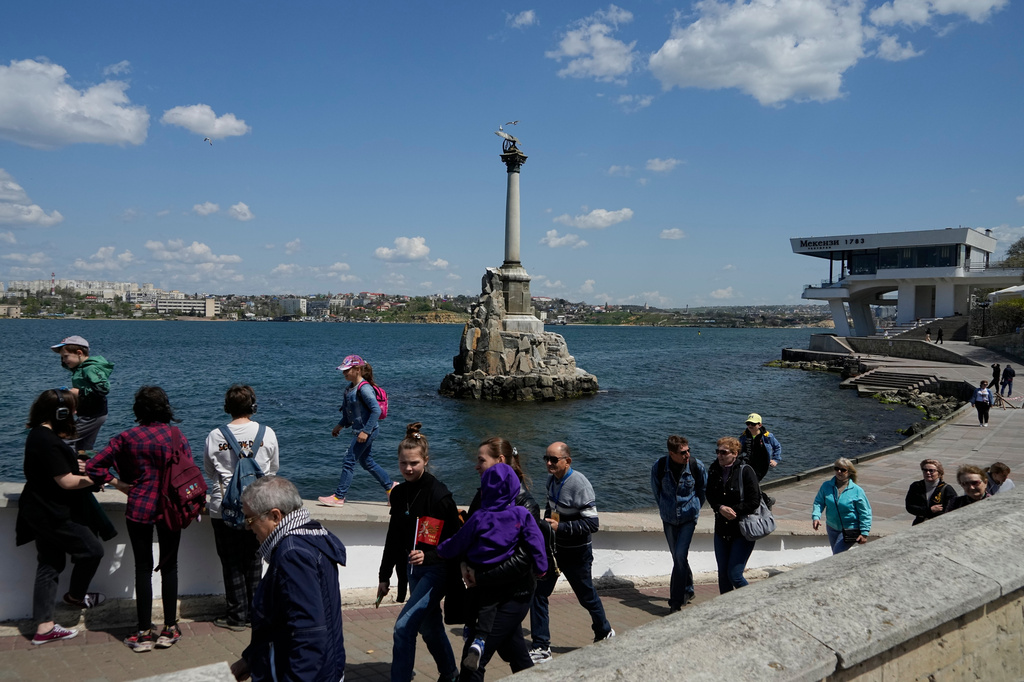 FILE - Tourists walk along an embankment in Sevastopol, Crimea, Monday, May 2, 2022. (AP Photo, File)