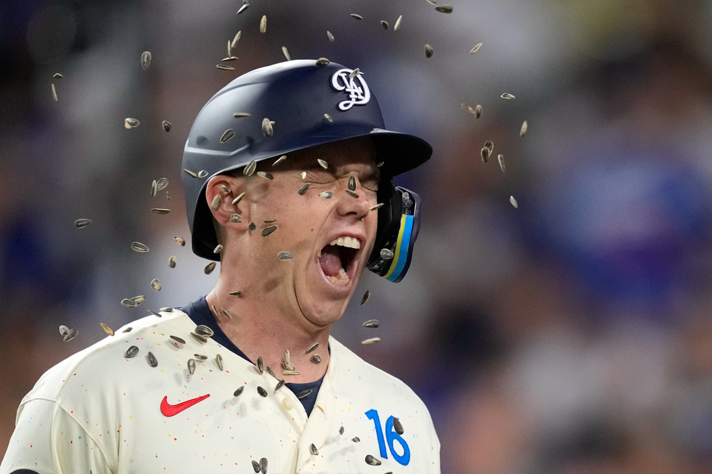 Los Angeles Dodgers' Will Smith has seeds thrown at him after hitting a solo home run during the third inning of a baseball game against the San Francisco Giants, Saturday, Sept. 19, 2026, in Los Angeles. (AP Photo/Mark J. Terrill)