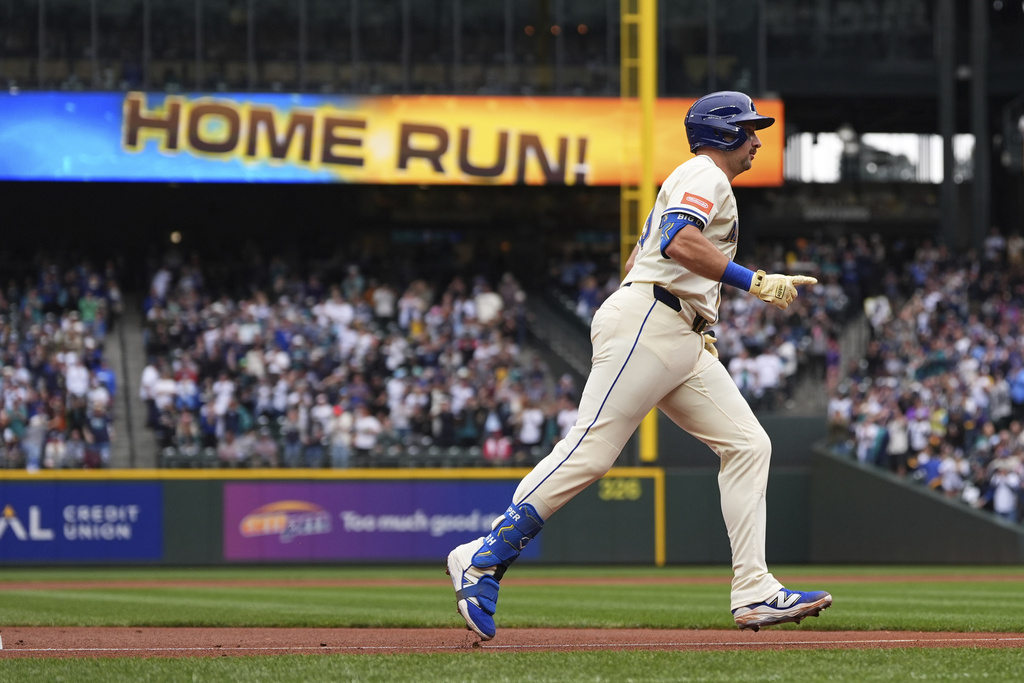 Seattle Mariners' Cal Raleigh jogs the bases after hitting his 54th home run of the season, a two-run home run to tie Mickey Mantle for most home runs by a switch-hitter in a single season, against the Los Angeles Angels during the first inning of a baseball game Sunday, Sept. 14, 2025, in Seattle. (AP Photo/Lindsey Wasson)