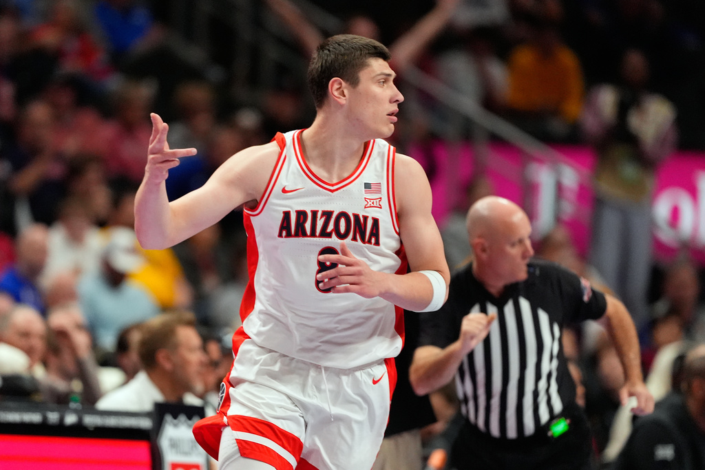 Arizona's Ivan Kharchenkov celebrates after making a 3-point basket during the first half of an NCAA college basketball game against UCF in the quarterfinal round of the Big 12 Conference tournament Thursday, March 12, 2026, in Kansas City, Mo. (AP Photo/Charlie Riedel)