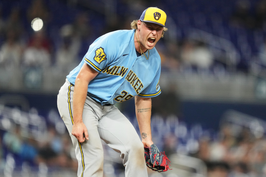 Milwaukee Brewers pitcher Trevor Megill reacts after getting the final out during the tenth inning of a baseball game against the Miami Marlins, Friday, April 17, 2026, in Miami. (AP Photo/Lynne Sladky)