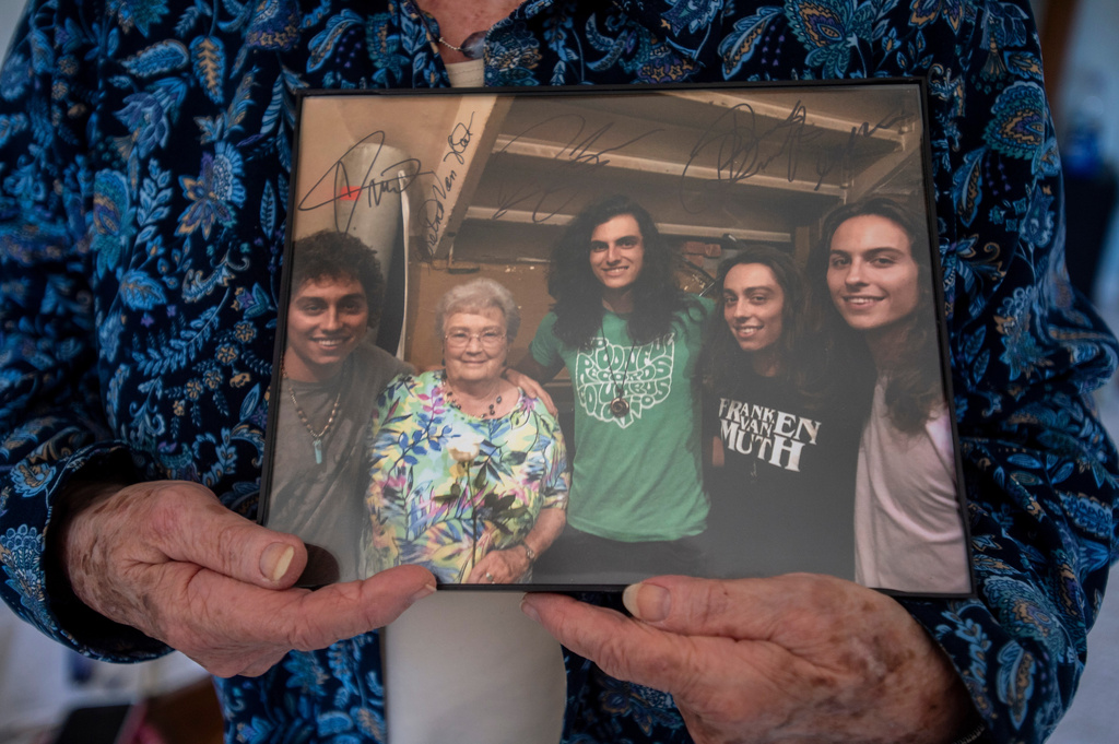 Gretna Van Fleet smiles holds a photograph of her with the band Greta Van Fleet at her home in Frankenmuth, Mich, Monday, Jan. 14, 2019. (Kaytie Boomer/Saginaw News via AP)